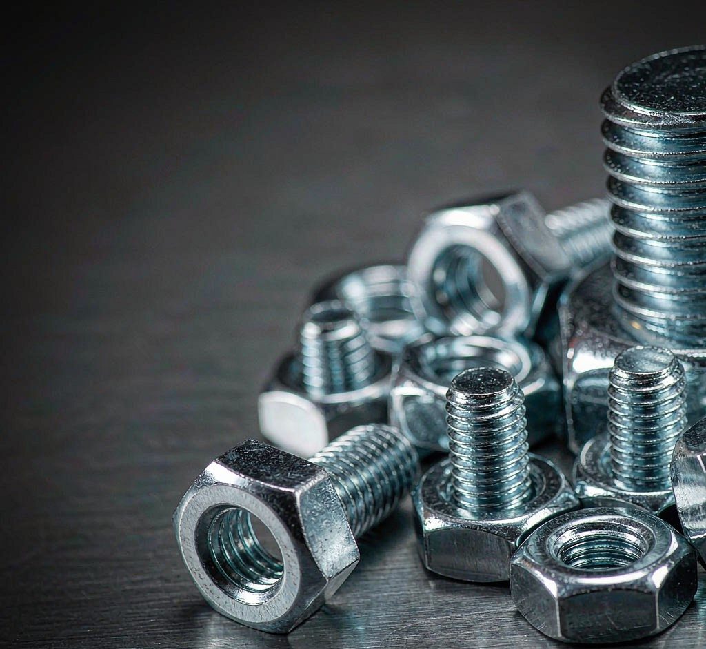 Zinc-plated hex bolts and nuts macro close-up