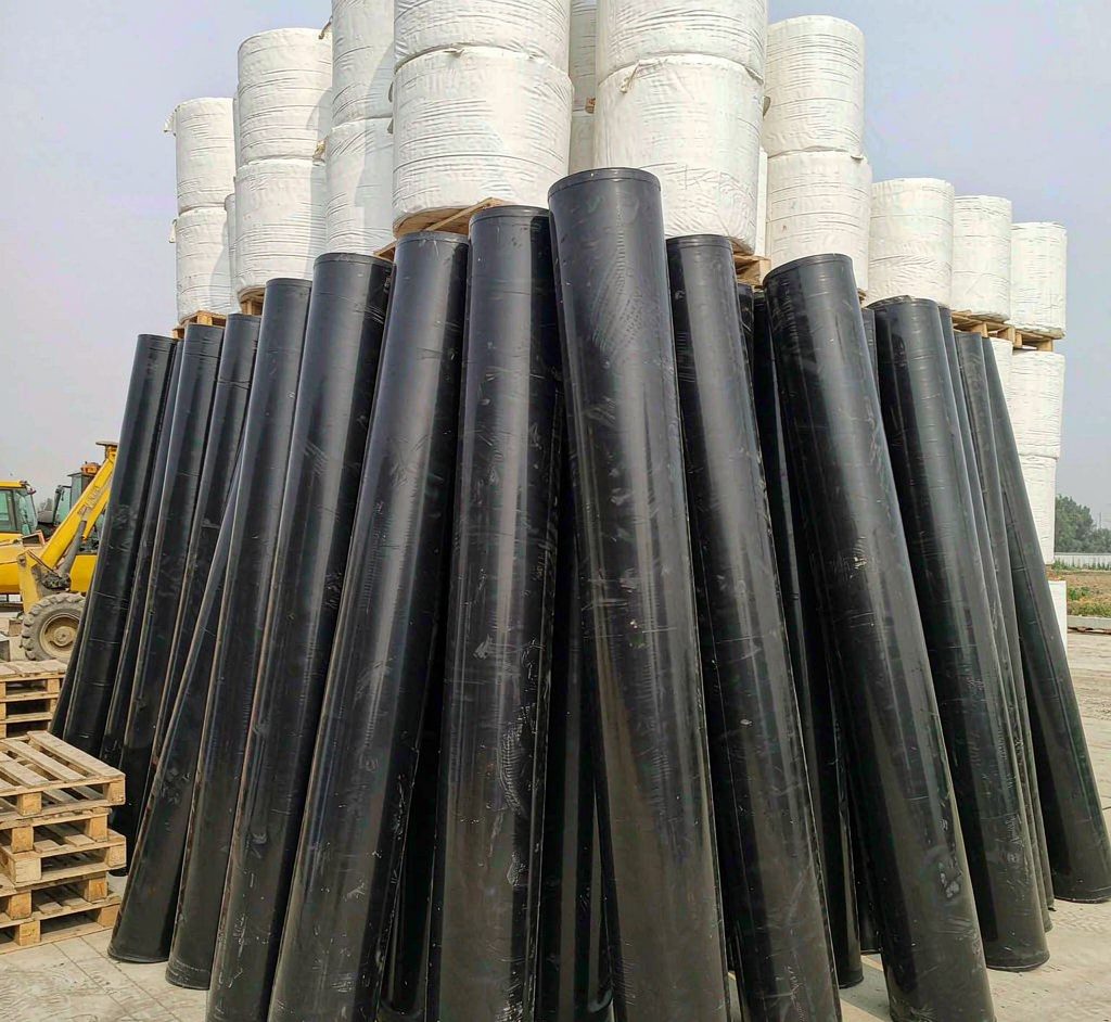 Rolls of geomembrane and geotextile fabric in a storage yard