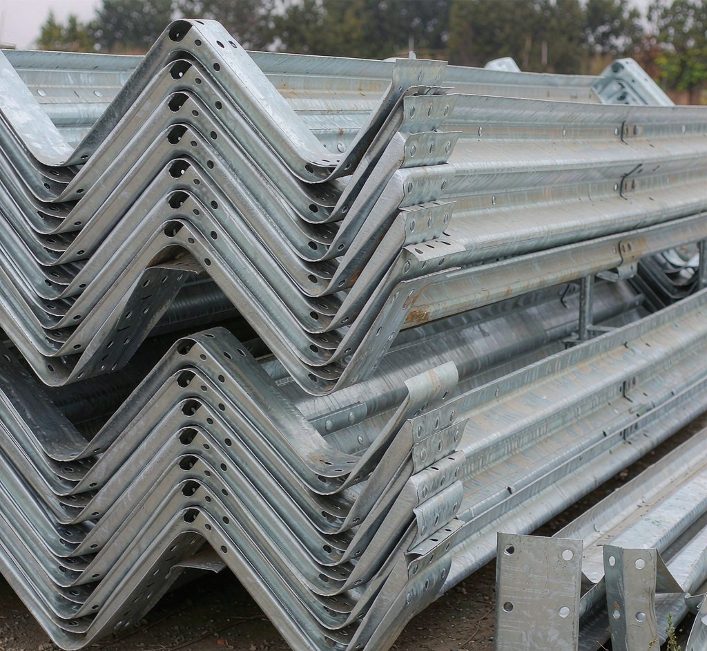 Hot-dip galvanized W-beam guardrail sections in a storage yard